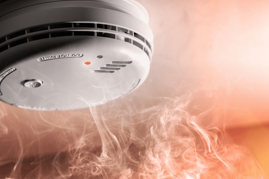 Picture showing a Domestic fire alarm receiving smoke to set it off